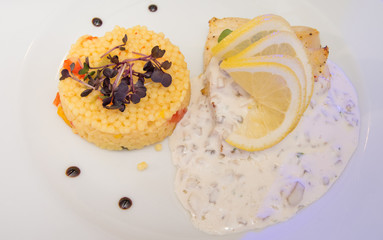 Couscous plate with vegetables, mushroom sauce and lemon