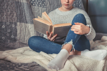 Cold autumn or winter weekend while reading a book and drinking Lazy day with cat on the sofa. Cosy...