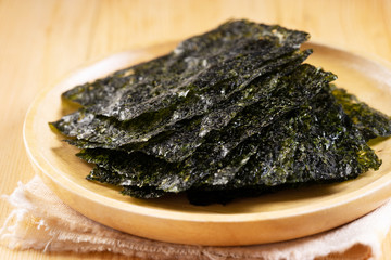 Crispy dried seaweed on wooden dish