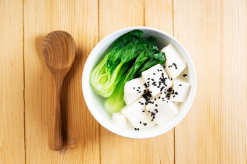 Tofu soup on wooden background