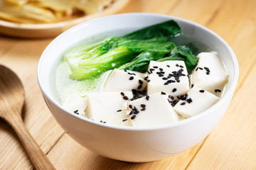 Tofu soup on wooden background