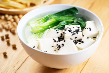 Tofu soup on wooden background