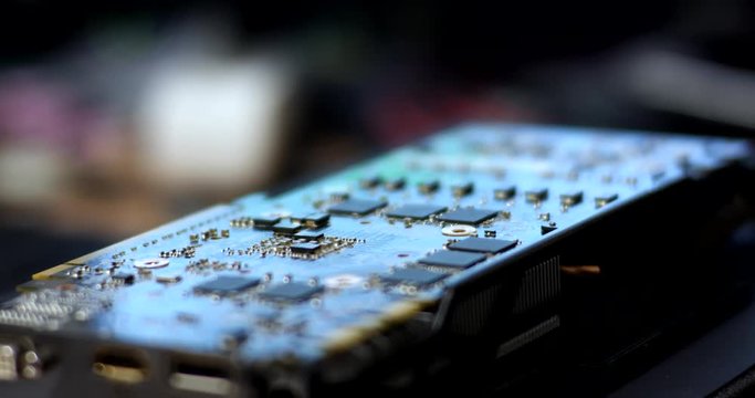 A professional man repairs a graphics card.