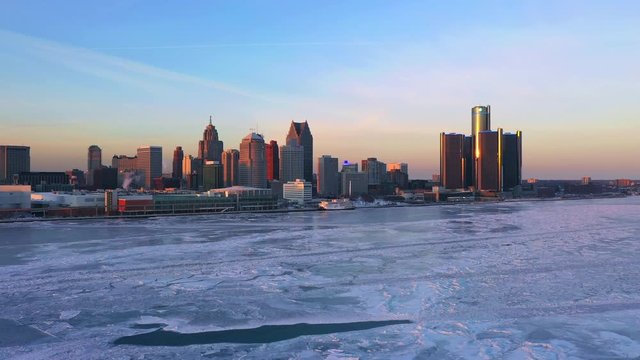 Frozen Detroit river with Renaissance center aerial view Winter Panorama at Sunset