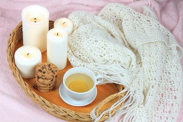 Hygge autumn or winter time for tea. Flat lay with tea, cookies, candles, lemon and scarf