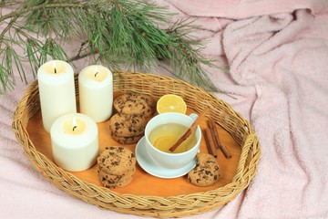 Hygge autumn or winter time for tea. Flat lay with tea, cookies, candles and pine branch