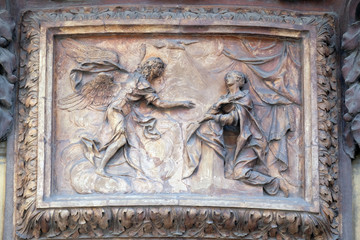 Relief of Annunciation scene on the house facade in Bologna, Italy