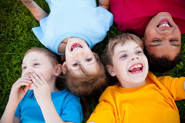 Laughing Kids Lying in Grass Outside