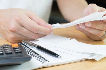Accounting, cost or profit and loss calculation concept, hand holding financial expense bills or...