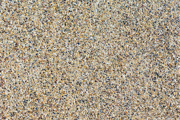 Backgrounds of sand stone wall. Small pebbles mixed with sand texted background.