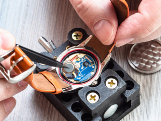 watchmaker repairs quartz wristwatch close up