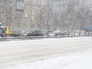snow-covered urban road in snowfall
