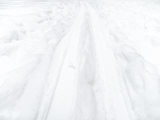 fresh ski track in snow-covered field