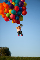Little Girl Floating Away with Bunch of Balloons