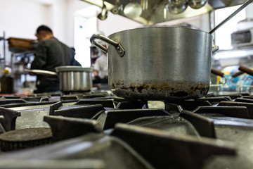 Silver spoons and steel tools in industrial kitchen. Gourmet restaurant before service, preparation and food processing concept. Master chef scene.