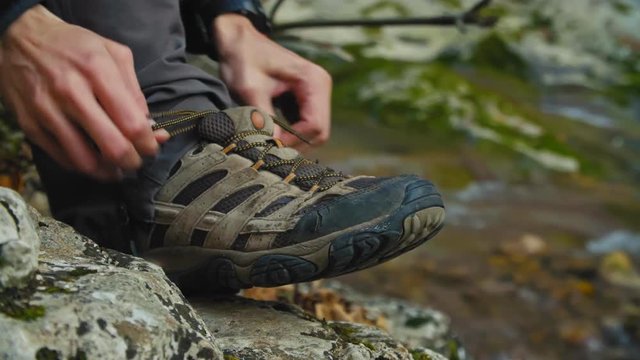 hiker tying shoelace on foggy highland mountain 4k