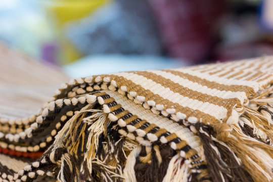 Detail of Brazilian handicraft doormat (capacho) stacked from northeast of Brazil . Feira de Sao Cristovao, Rio de Janeiro, Brazil. Blurred and colorful background 2017