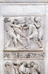 Fototapeta na wymiar Joseph thrown into the cistern by Amico Aspertini, right door of San Petronio Basilica in Bologna, Italy