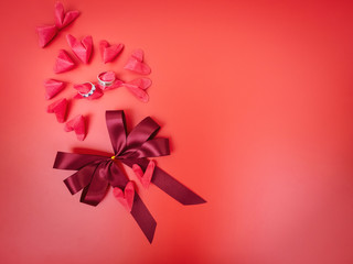 flat lay and minimal of love object in valentine's day concept from paper heart and wedding ring decorate on red background
