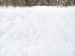 footprints and ski tracks at snowy surface