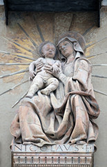 Fototapeta na wymiar Virgin Nary with baby Jesus statue on house facade in Bologna, Italy