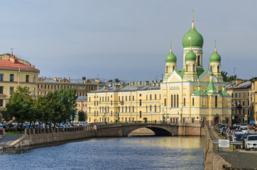 Griboyedov Canal embankment with the  Mogilyovsky Bridge and the St.Isidore Church in St.Petersburg, Russia