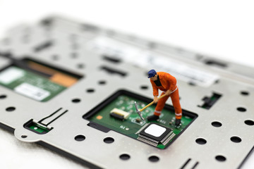 Miniature people: Worker repairing circuit board ,electronics repair. Use image for support and maintenance business.