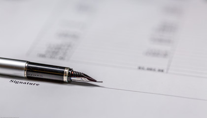 Fototapeta premium Fountain Pen Lie on Business Signature Contract Document