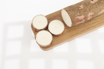 Raw yucca on white background-Manihot esculenta. (Cassava raw tuber)