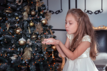 little girl decorating christmas tree