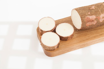 Raw yucca on white background-Manihot esculenta. (Cassava raw tuber)