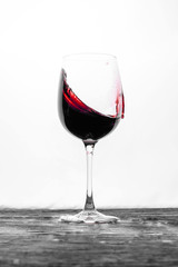 Red wine in the glass splashes in motion on a white background. Stylish design drink card