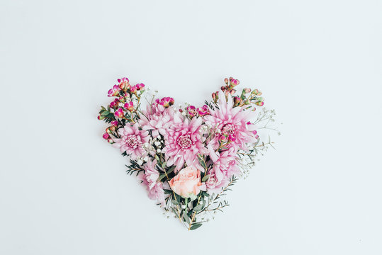 The heart is laid out from flowers on a white background.