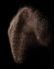Dry soil splash or explosion flying in the air on black background,Stop motion