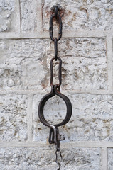 Medieval shackles mounted in old stone wall on Town Hall square in old Tallinn, Estonia - Image