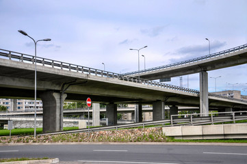 Modern city landscape with multi-level road passage - image