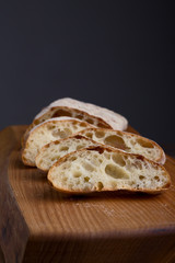 homemade fresh bread on a wooden board. ciabatta