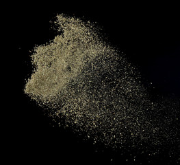 Oregano spice splash or explosion flying in the air isolated on black background,Motion blur