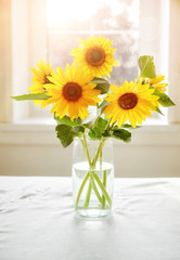Bouquet sunflowers on sunny window Summery still
