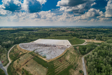 Garbage trucks unload garbage to a landfill