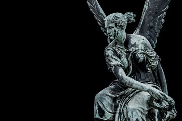 Statue of ancient beautiful winged angel in downtown of Potsdam, isolated at black background,...