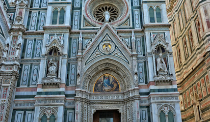 Duomo Florence Cathedral is the third largest church in the world. Italian Renaissance. Architectural details of awesome marble facade with sculptures, painting, rosettes. Italy, Florence