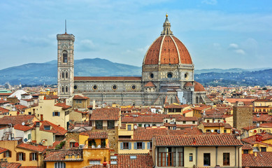 Aerial view of Duomo Florence Cathedral and buildings in the old city. The medieval Cathedral with iconic red dome is the third largest church in the world. Panoramic skyline. Italy, Florence