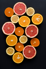 Orange, Grapefruit, Mandarine And Lemon Fruit On Black Background