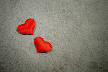 Valentines day background with red hearts on old concrete table. - Love and care concept .