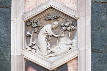 Fototapeta na wymiar Creation of Adam: Andrea Pisano, 1334-36., Relief on Giotto Campanile of Cattedrale di Santa Maria del Fiore (Cathedral of Saint Mary of the Flower), Florence, Italy