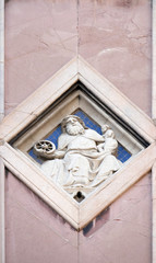 Fototapeta na wymiar Saturn by Collaborator of Andrea Pisano, Relief on Giotto Campanile of Cattedrale di Santa Maria del Fiore, Florence, Italy 