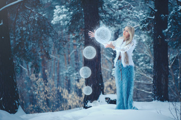 Winter Beauty Woman. Beautiful fashion model girl with snow hairstyle and makeup in the winter...
