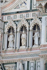 Fototapeta na wymiar Statues of the Apostles and the fine architectural detail of the of the, Portal of Cattedrale di Santa Maria del Fiore (Cathedral of Saint Mary of the Flower), Florence, Italy 