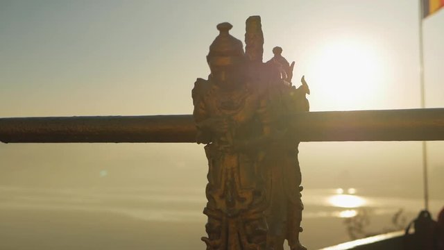 banister with buddha statue sunset river flag slow motion